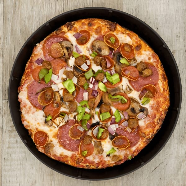 Pijja Paradise pizza with pepperoni, sausage, mushrooms, green peppers, and red onions in a pan.